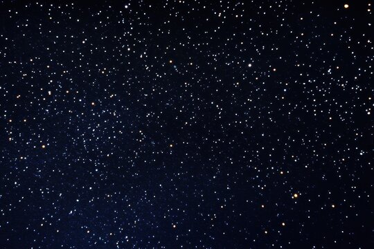 Starry night floating gold sparkles on dark navy background wallpaper. Starry Night Sky, Navy background adorned with shimmering gold sparkles resembling a starry night sky