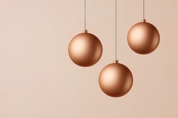 Elegant copper ornaments hanging against a soft beige backdrop create warmth
