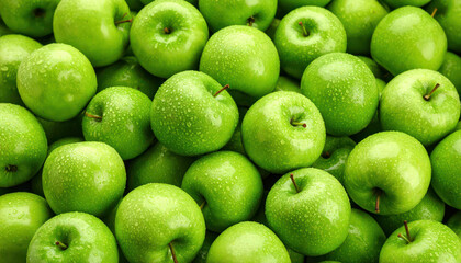 Many ripe juicy green apples covered with water drops as background
