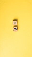 Wooden blocks showing the date April 1 on a vibrant yellow background. A symbolic flat lay...