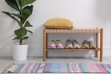 Different footwear on shelf in hallway indoors