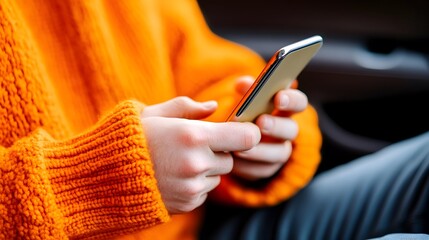 Person texting on phone in car, autumn