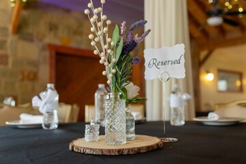Elegant table setting with reserved sign and floral centerpiece.