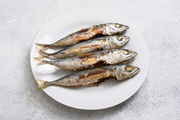 Traditional Indonesian food Ikan pindang goreng, fried salted fish on white table