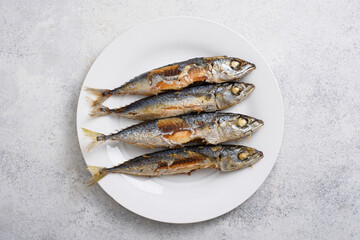 Traditional Indonesian food Ikan pindang goreng, fried salted fish on white table