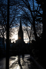 Silhouette Morning Walk under Church Spire and Winter Trees