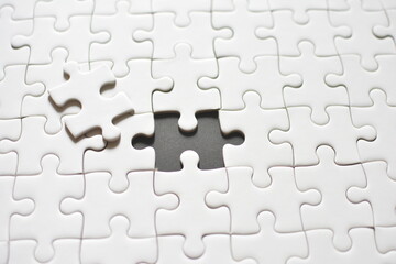white puzzle with missing piece