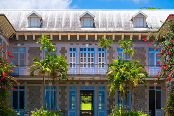 Big historic manor house in Saint Pierre on Martinique island (France) with old garden and tropical vegetation. Well kept and renovated public museum of a caribbean rum distillery. Tourist attraction.