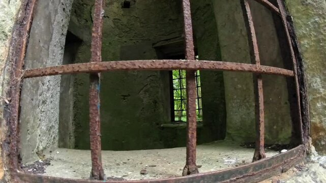 Old medieval stone castle rusted iron bars covering open window for protection