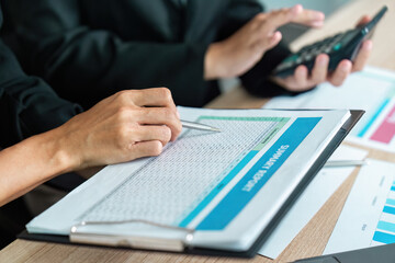 Collaborative Financial Review. Professional discussing financial report with colleague.