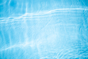 Blue water with ripples on the surface. Defocus blurred transparent blue colored clear calm water...