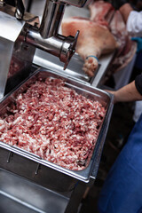 Mincer and pork meat for delicatessen