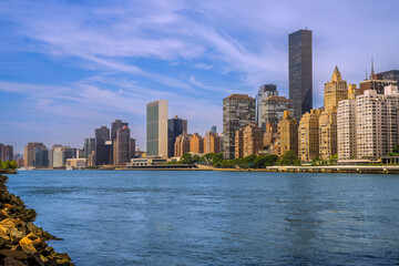 New York City skyline and Upper East Side buildings and skyscrapers as seen from Roosevelt Island at golden hour over the East River, USA