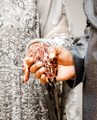 Bridal Mehndi: Close-up of a Couple's Hands Intertwined