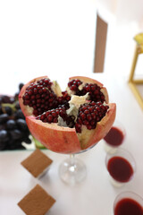 Peeled red ripe pomegranate on a buffet table.
