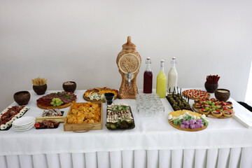 Beautiful, delicious buffet table with canapes, sausages, ham, cheese