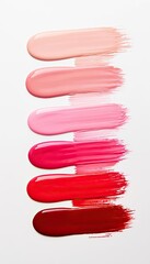 Colorful brushstrokes of lip gloss in various shades including red, pink, and nude. The texture is smooth and glossy.