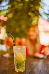 a glass of a cocktail with selective focus and blurred background