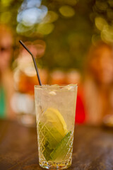 a glass of a cocktail with selective focus and blurred background