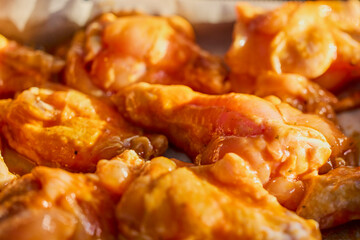 Chicken wings with tomato sauce and paprika ready to be cooked