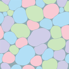 A seamless pattern of colorful pastel stones on a muted blue-gray background. Vector Patterns