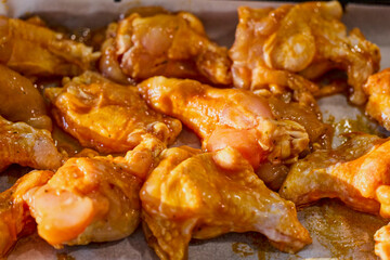 Chicken wings with tomato sauce and paprika ready to be cooked