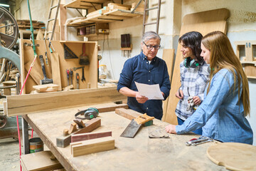 Lumberyard teamwork with experienced and young workers collaborating