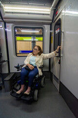 Businesswoman in wheelchair opening subway door while traveling. Concept of inclusion, adapted