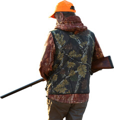 Mature man hunter with gun while walking on field.
