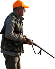 Mature man hunter with gun while walking on field.