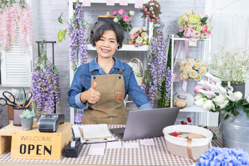 Senior, woman, florist small business owner, entrepreneur happily opening flower shop, showing...
