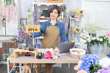 Asian senior woman, florist, small business, owner, entrepreneur manage store accounting with laptop at flower shop, independent lifestyle, creative workspace, passion for business, and modern skills