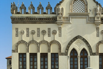 Close-up of a historic building in Rhodes, Greece, façade displays decorative arched windows,...