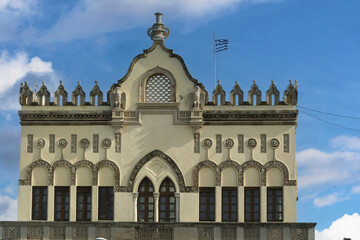 Close-up of a historic building in Rhodes, Greece, façade displays decorative arched windows,...