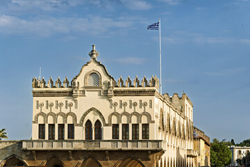 Close-up of a historic building in Rhodes, Greece, façade displays decorative arched windows,...