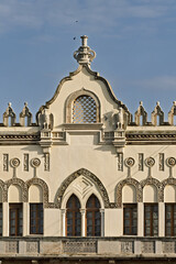 Close-up of a historic building in Rhodes, Greece, façade displays decorative arched windows,...