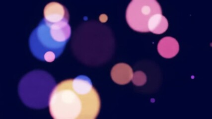 Colorful abstract bokeh lights floating on black background, soft dreamy atmosphere
