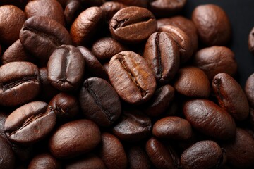 A closeup of roasted coffee beans showcasing their brown color shape and texture