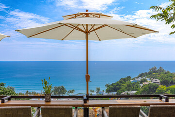 Kata Beach Hill top view overlooking the turquoise blue waters of the Andaman sea at Kata Beach with sweeping views of lush green mountains on the island of Phuket Thailand