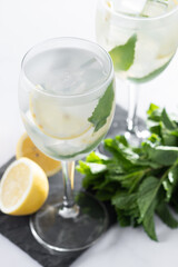 Hugo Spritz cocktail in glass on white marble background