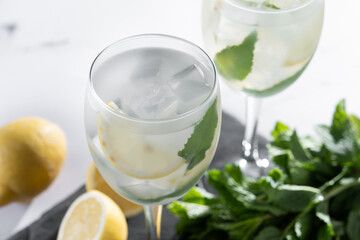 Hugo Spritz cocktail in glass on white marble background