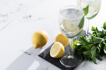 Fototapeta premium Hugo Spritz cocktail in glass on white marble background. Copy space