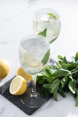 Hugo Spritz cocktail in glass on white marble background