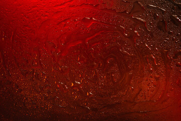 Wet glass. Drops on glass. Abstract dark red texture. Light spots