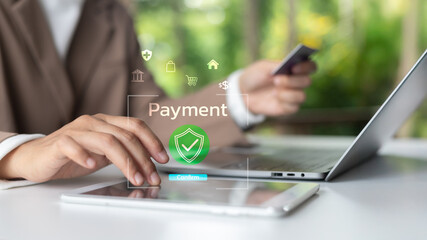 A person making an online payment using a tablet and credit card with security confirmation....