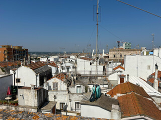 A town in Puglia, a region in southern Italy. White buildings, red tiled roofs and many antennas...