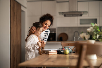 Mother and Daughter Sharing a Loving Moment in Modern Home Kitchen