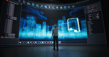 Architectural Engineer in a VR Headset Designs Futuristic Cityscapes on a Big Panoramic Digital...