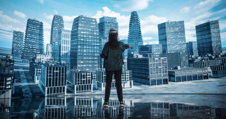 Female Architect Wearing a Virtual Reality Headset and Using Controllers for Creating an Urban...