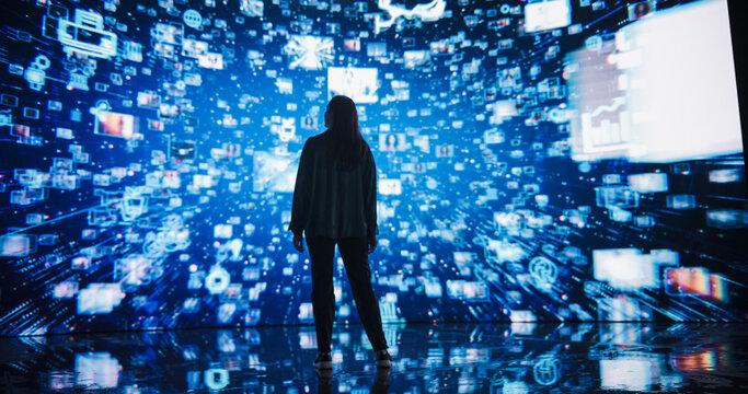 Young Woman Standing Before a Dynamic Digital Screen, Immersed in Internet Visualization. Internet Cyberspace with Web Content, Icons, Animated Stream of Online Applications and Entertainment
